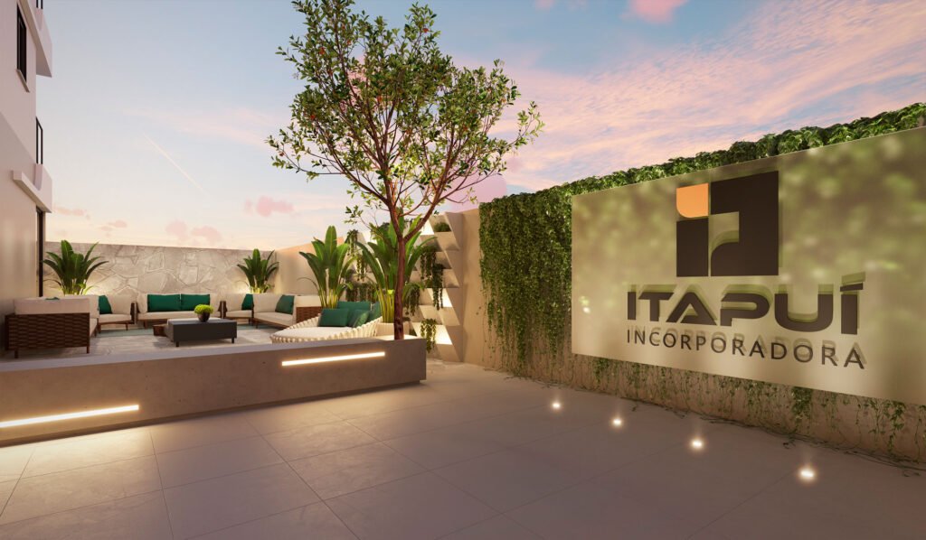 Área de convivência do Residencial Belize, da Itapuí Incorporadora, em Itapema (SC). O espaço exibe um ambiente sofisticado e acolhedor, com sofás em tons neutros, almofadas verde-esmeralda, vegetação exuberante e iluminação suave ao entardecer, refletindo o estilo contemporâneo e o cuidado estético característicos dos empreendimentos da incorporadora.